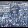 Aerial photo of the Alma Mater statue with a crowd of people holding signs to support Ukraine and wearing blue and yellow.